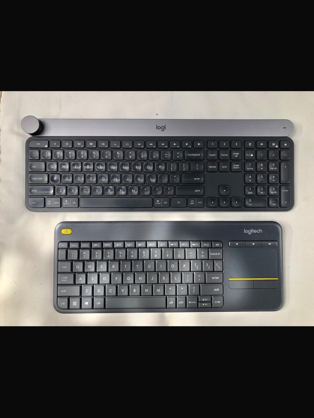 Two keyboards Logi and Logitech Slim Wireless Keyboards — Dark Gray